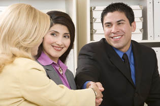 Woman shaking man's hand as if to congratulate him